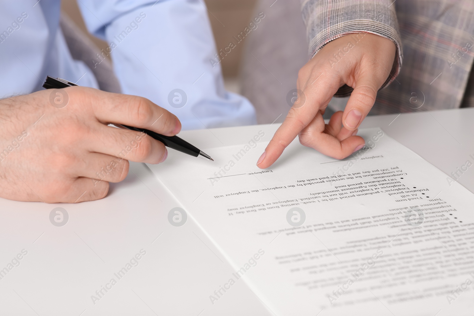 Photo of Businesspeople signing contract at white table, closeup of hands