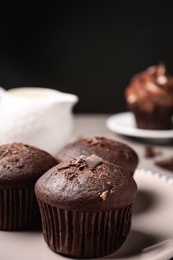 Photo of Delicious chocolate muffins on plate, closeup view