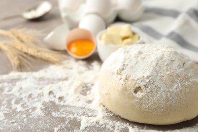 Photo of Wheat dough and products on table, closeup view with space for text. Cooking pastries