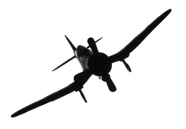 Dark silhouette of vintage toy military airplane on white background