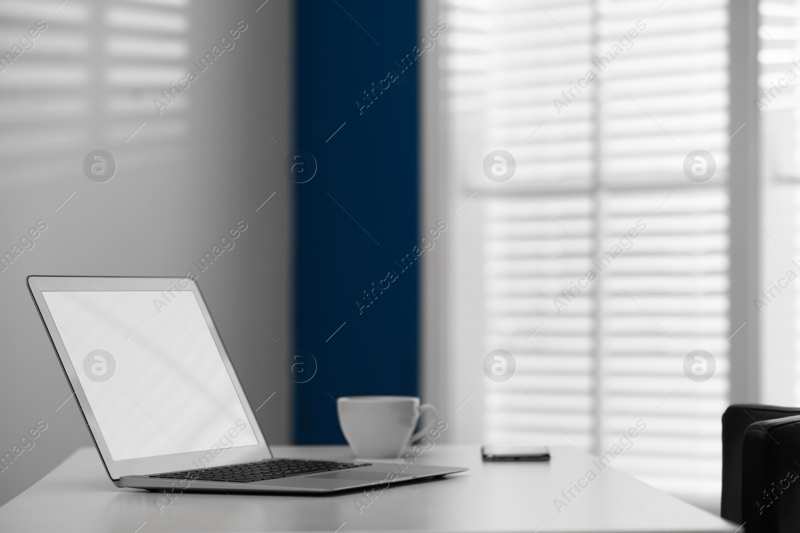 Photo of Comfortable workplace with modern laptop on desk in home office, space for text