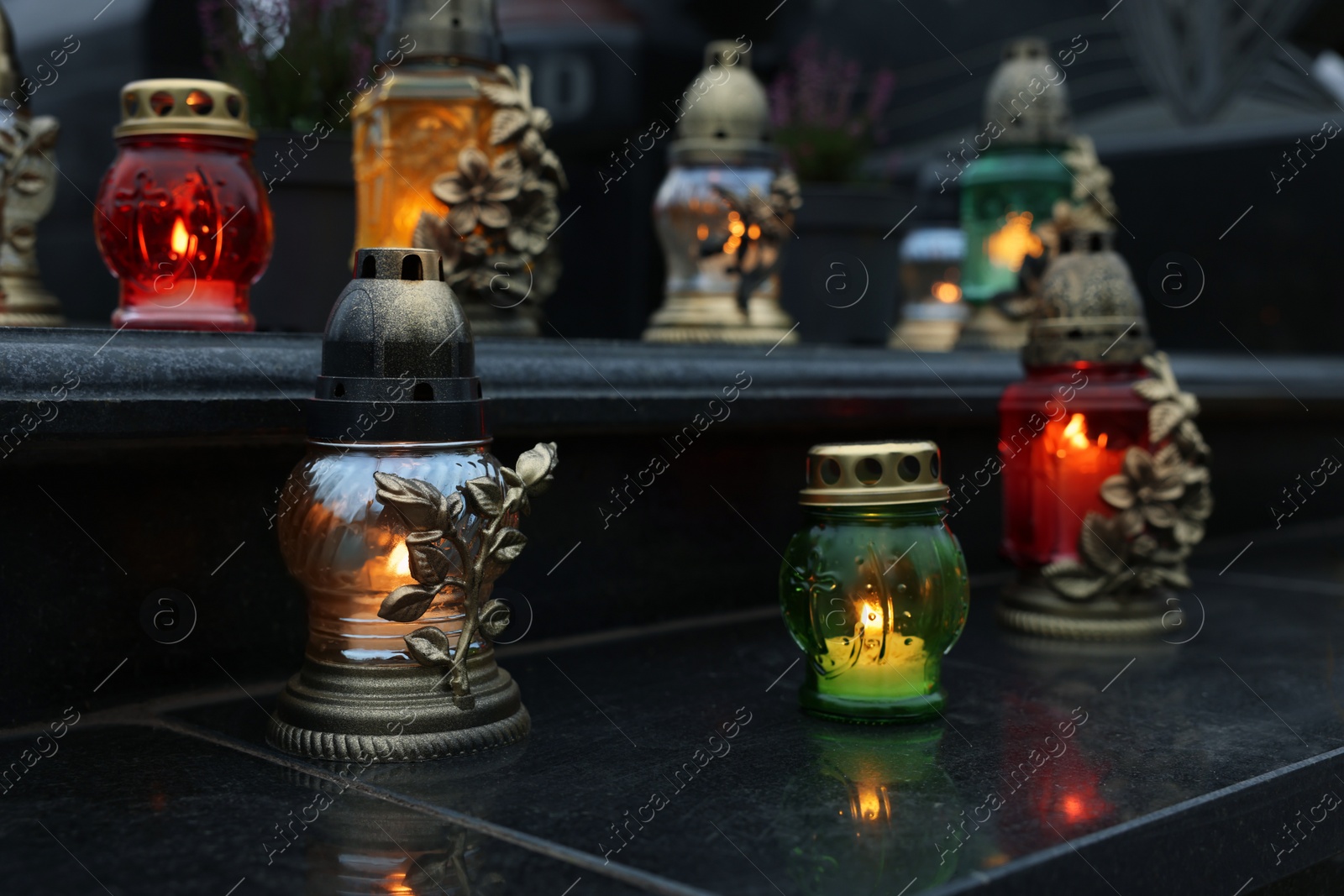 Photo of Grave lights on granite surface at cemetery