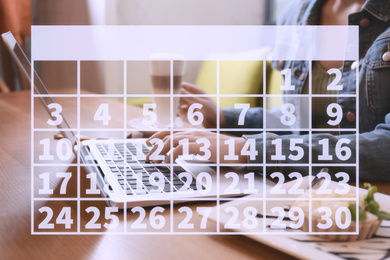 Calendar and woman working with laptop in cafe, closeup