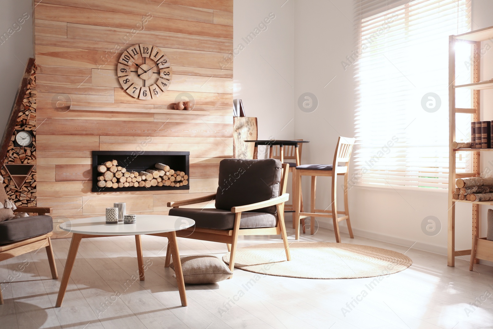 Photo of Decorative fireplace with stacked wood in cozy living room interior