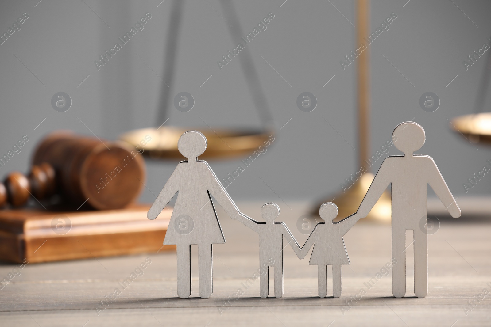 Photo of Family law. Figure of parents with children, scales and gavel on wooden table, space for text