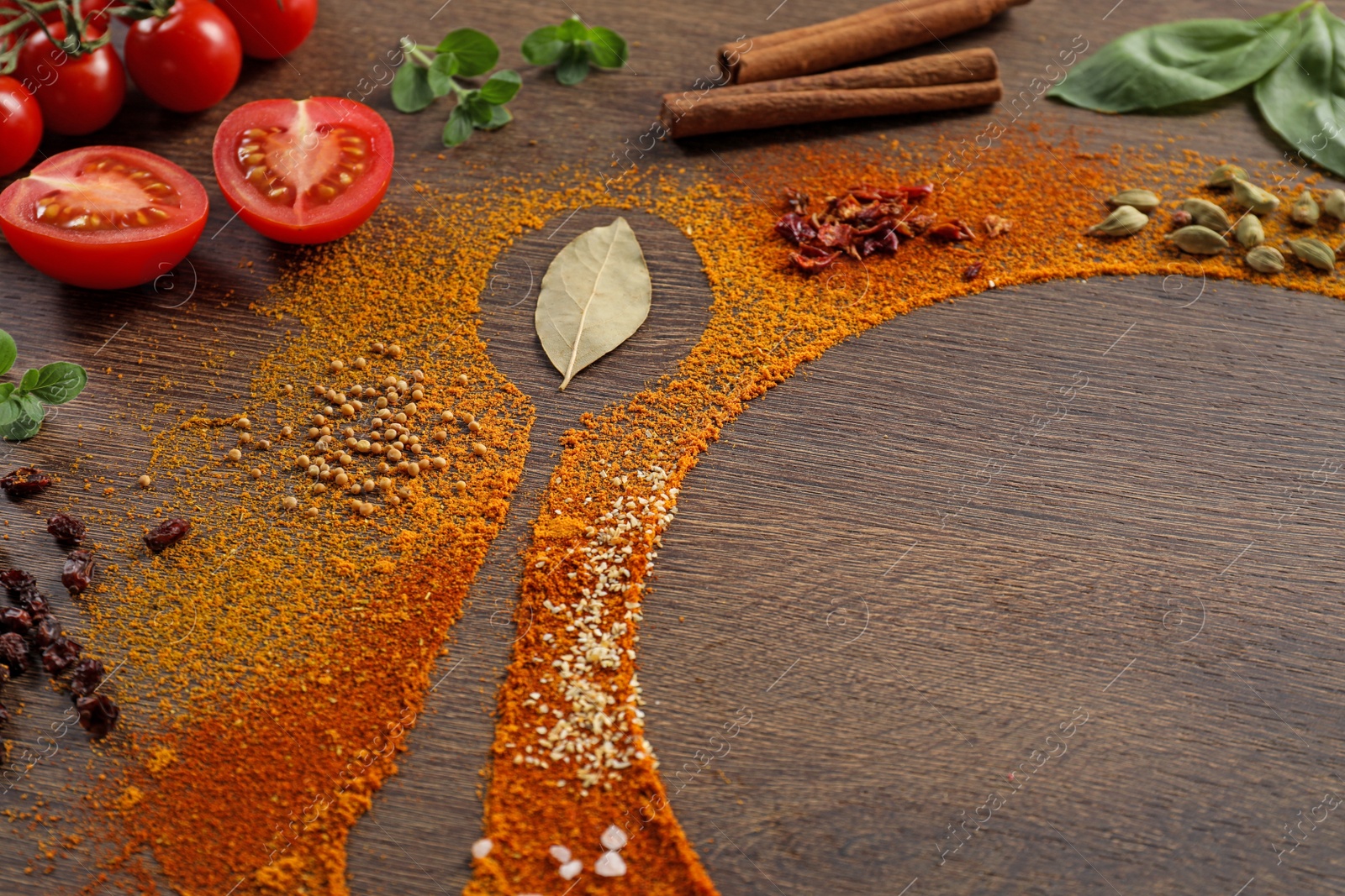 Photo of Silhouettes of spoon and plate made with spices and ingredients on wooden table