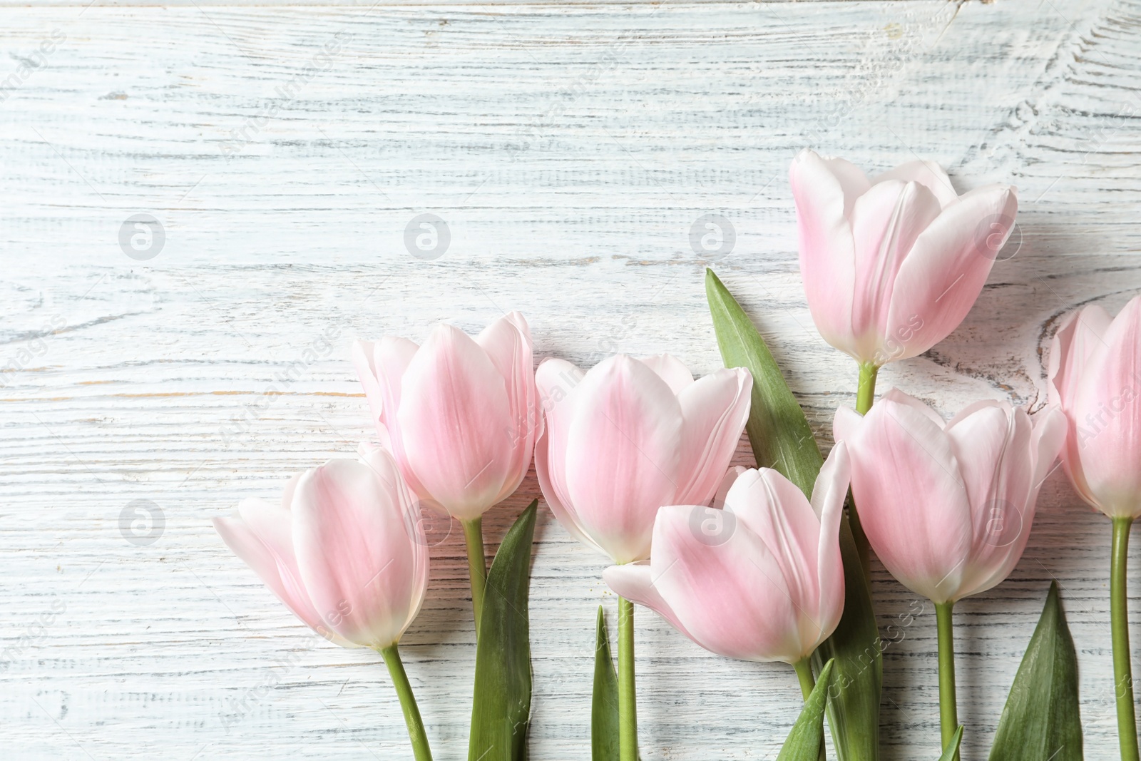 Photo of Beautiful composition with tulips for Mother's Day on wooden background