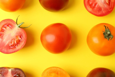 Photo of Flat lay composition with fresh ripe tomatoes on yellow background