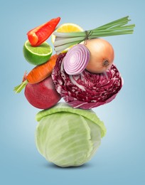 Image of Stack of different vegetables and fruits on pale light blue background