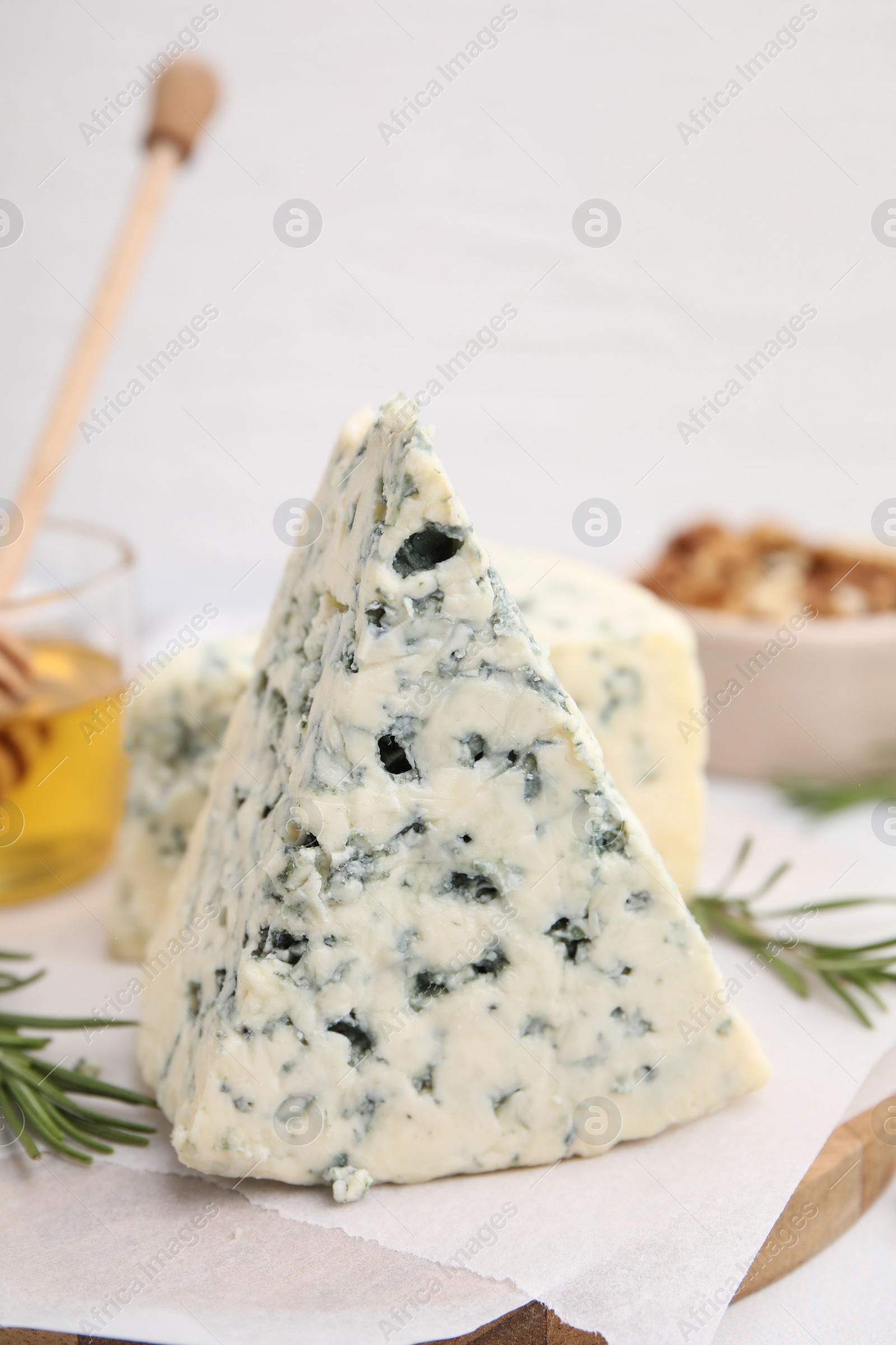 Photo of Tasty blue cheese with rosemary on white table