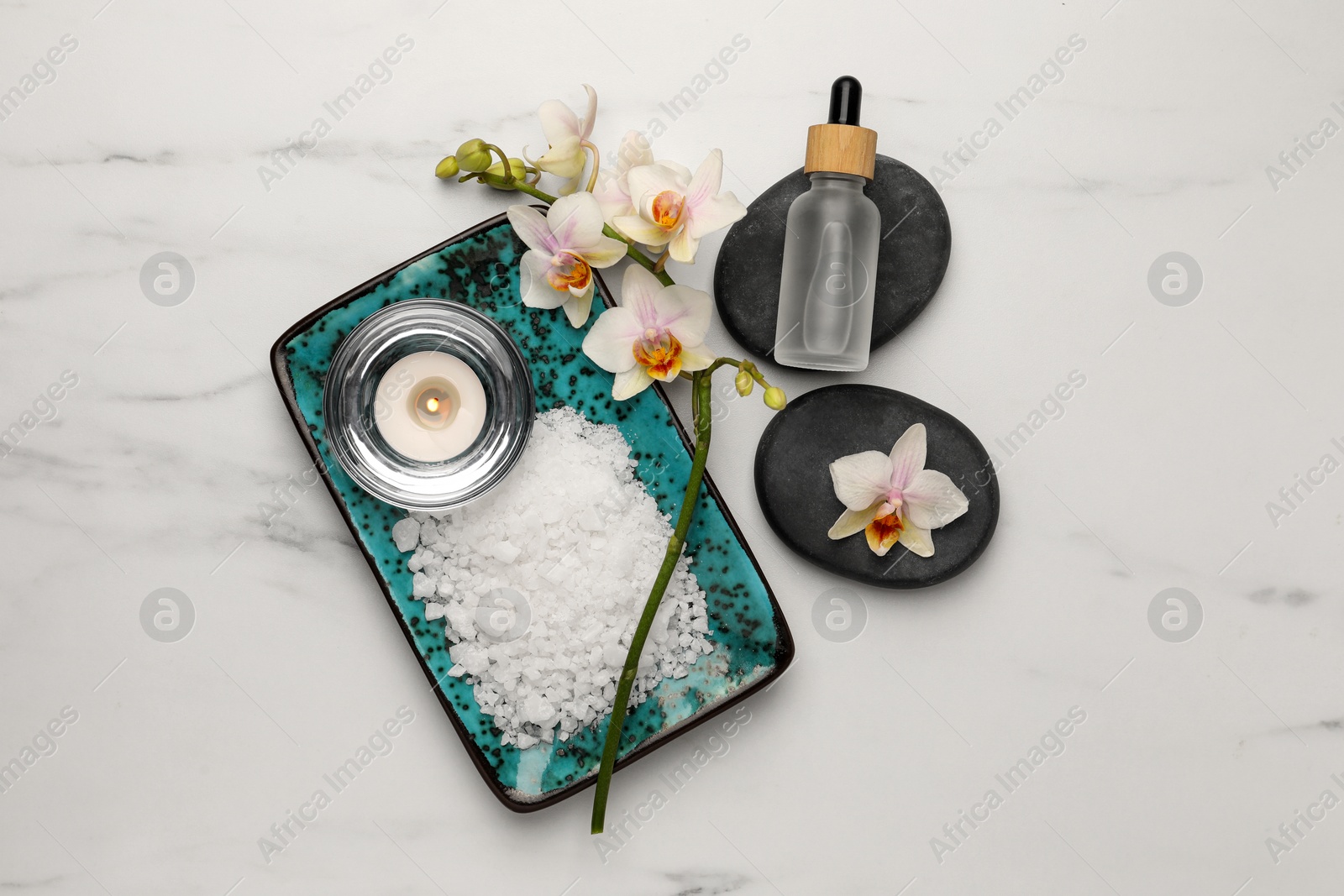 Photo of Flat lay composition with different spa products and flowers on white marble table