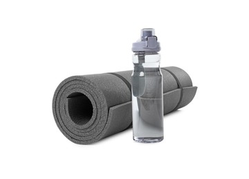 Photo of Grey yoga mat and bottle of water isolated on white