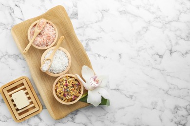 Photo of Flat lay composition with different spa products and orchid on white marble table. Space for text