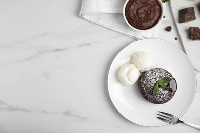 Photo of Delicious fresh fondant with hot chocolate, mint and ice cream served on white table, flat lay. Space for text