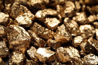 Photo of Pile of gold nuggets as background, closeup