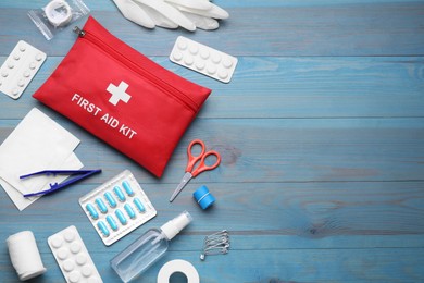 Photo of Flat lay composition with first aid kit on blue wooden table, space for text