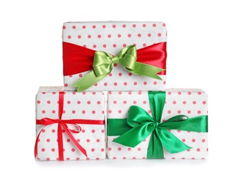 Photo of Beautifully wrapped gift boxes on white background