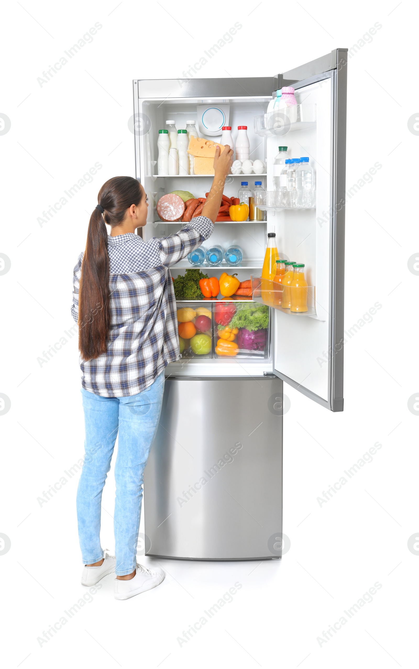 Photo of Young woman taking cheese from refrigerator on white background