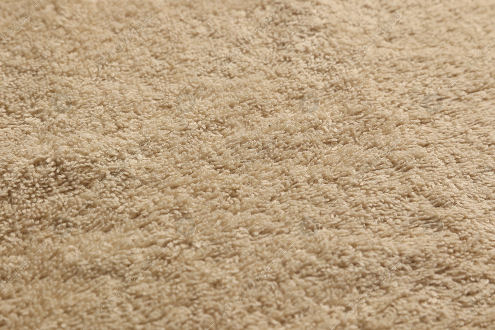 Photo of Dry soft beige towel as background, closeup