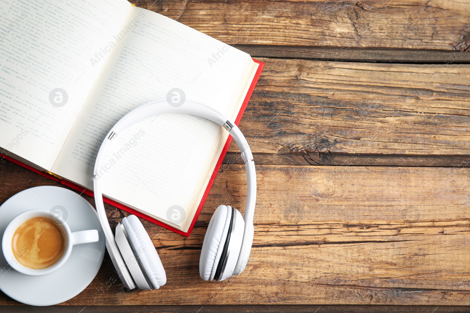 Photo of Book, coffee and headphones on wooden table, flat lay. Space for text