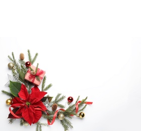 Flat lay composition with beautiful poinsettia and gift on white background, space for text. Christmas traditional flower
