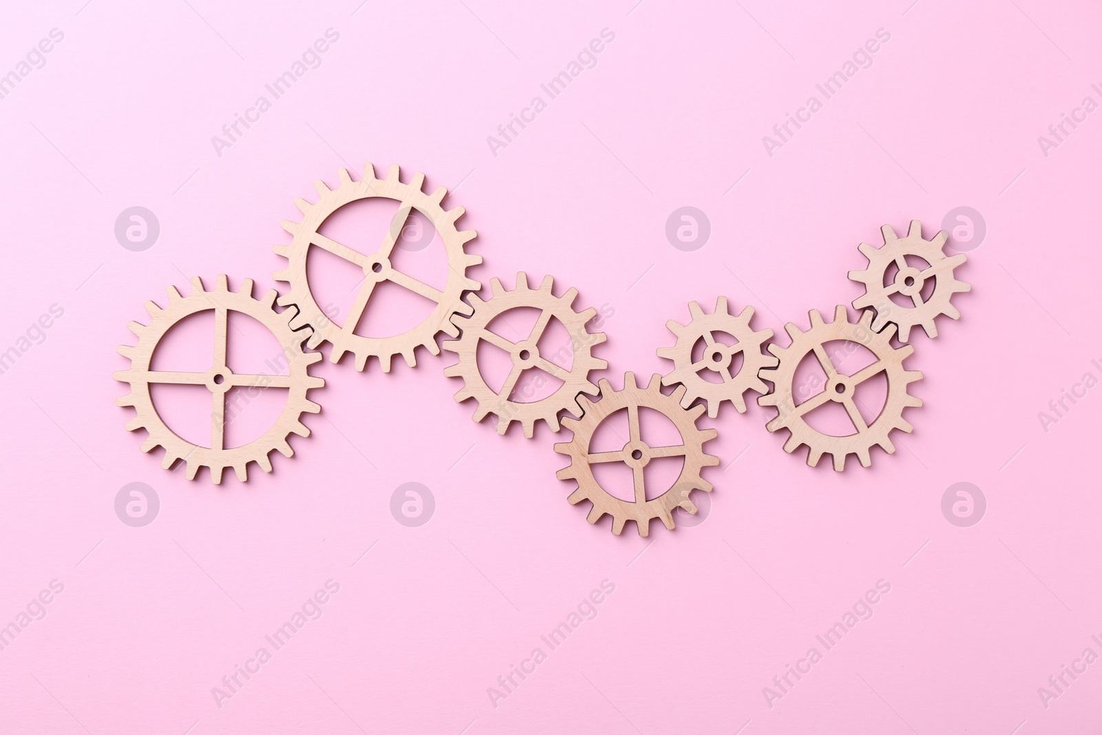 Photo of Business process organization and optimization. Scheme with wooden figures on pink background, top view