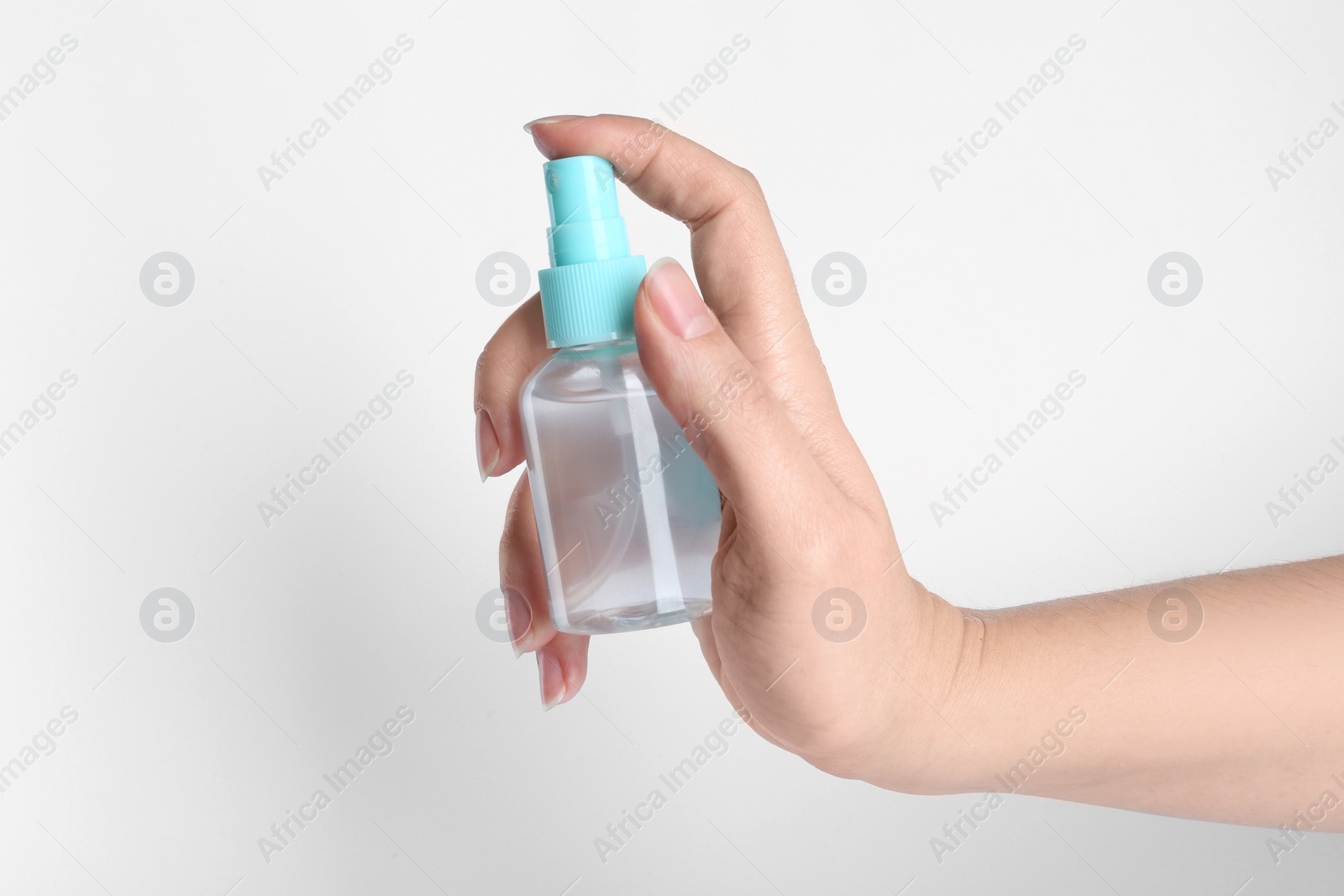 Photo of Woman holding antiseptic spray on white background, closeup