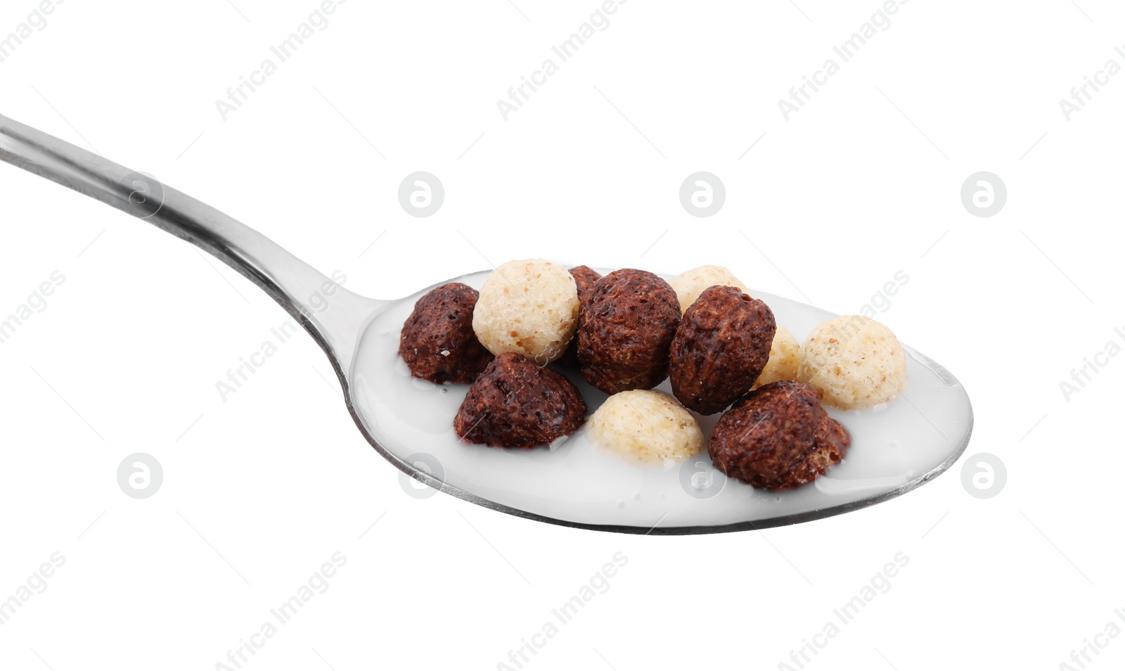 Photo of Cereal balls and milk in spoon isolated on white