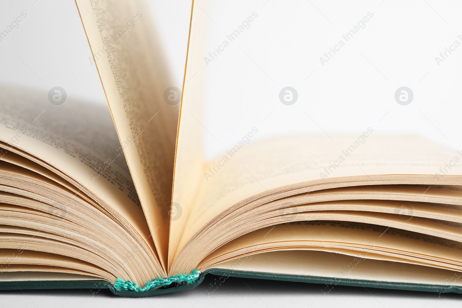 Photo of Closeup view of open book on white background