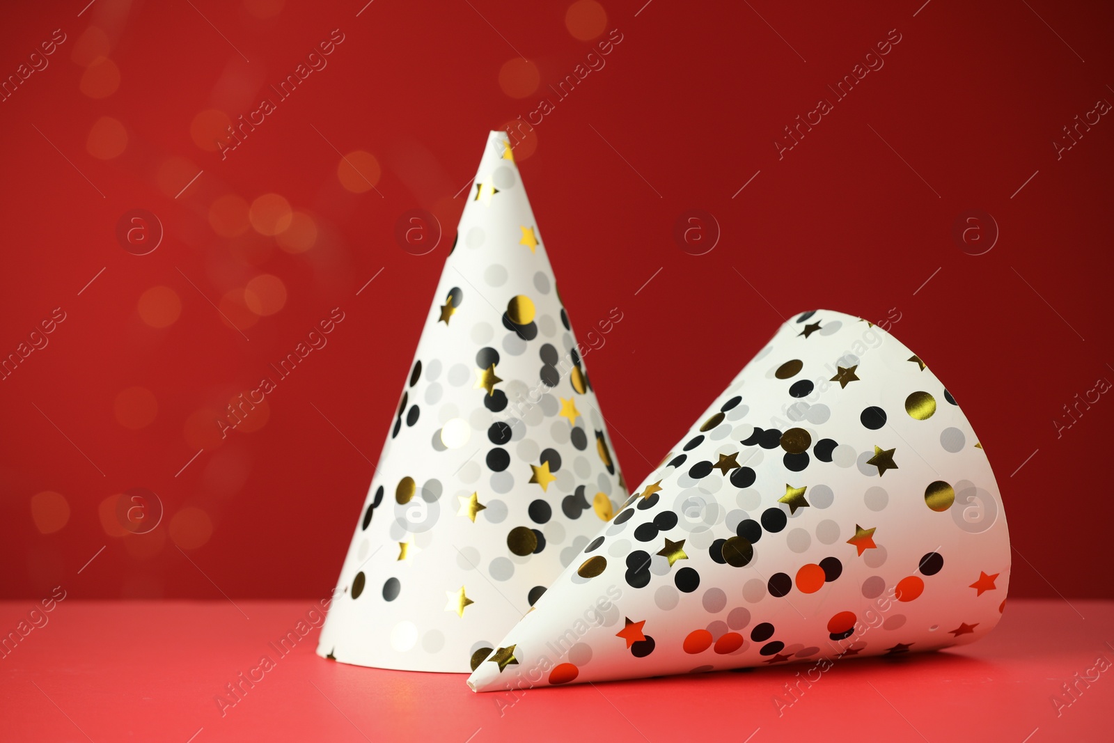 Photo of Two beautiful party hats on red background