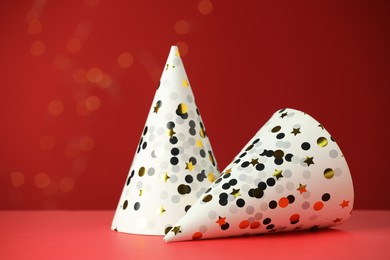 Two beautiful party hats on red background