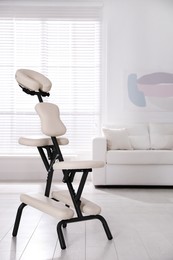 Photo of Modern massage chair in office, space for text. Medical equipment