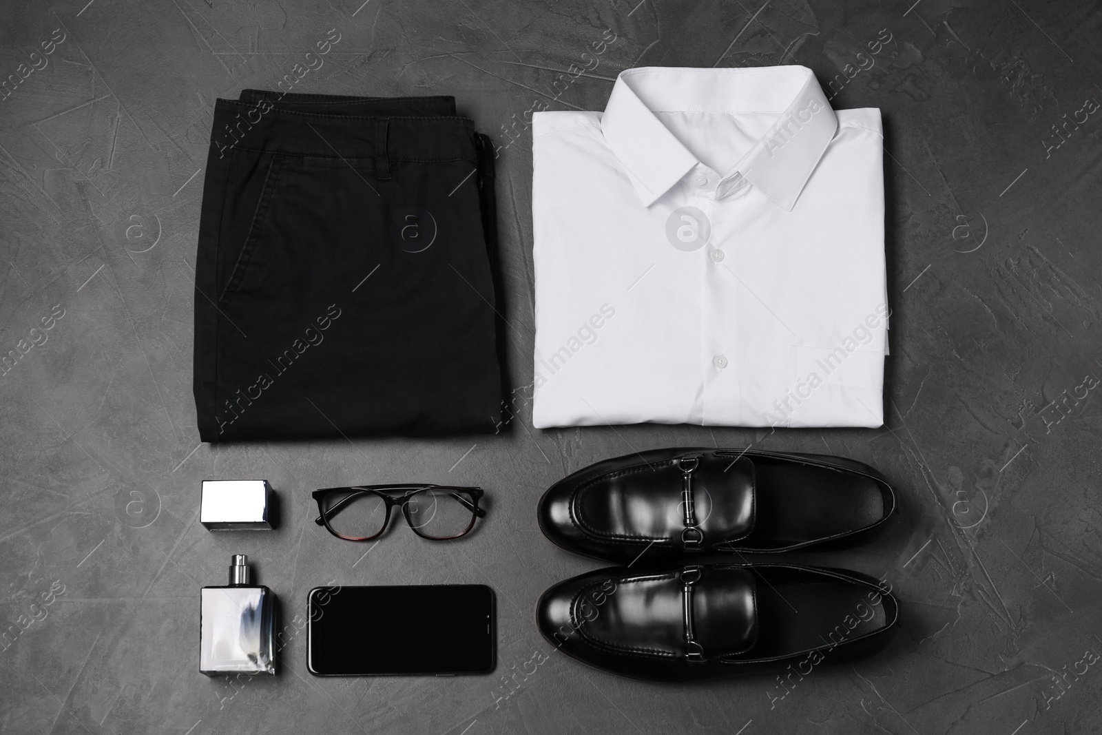 Photo of Flat lay composition with stylish clothes and accessories on grey stone background