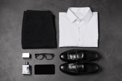 Photo of Flat lay composition with stylish clothes and accessories on grey stone background