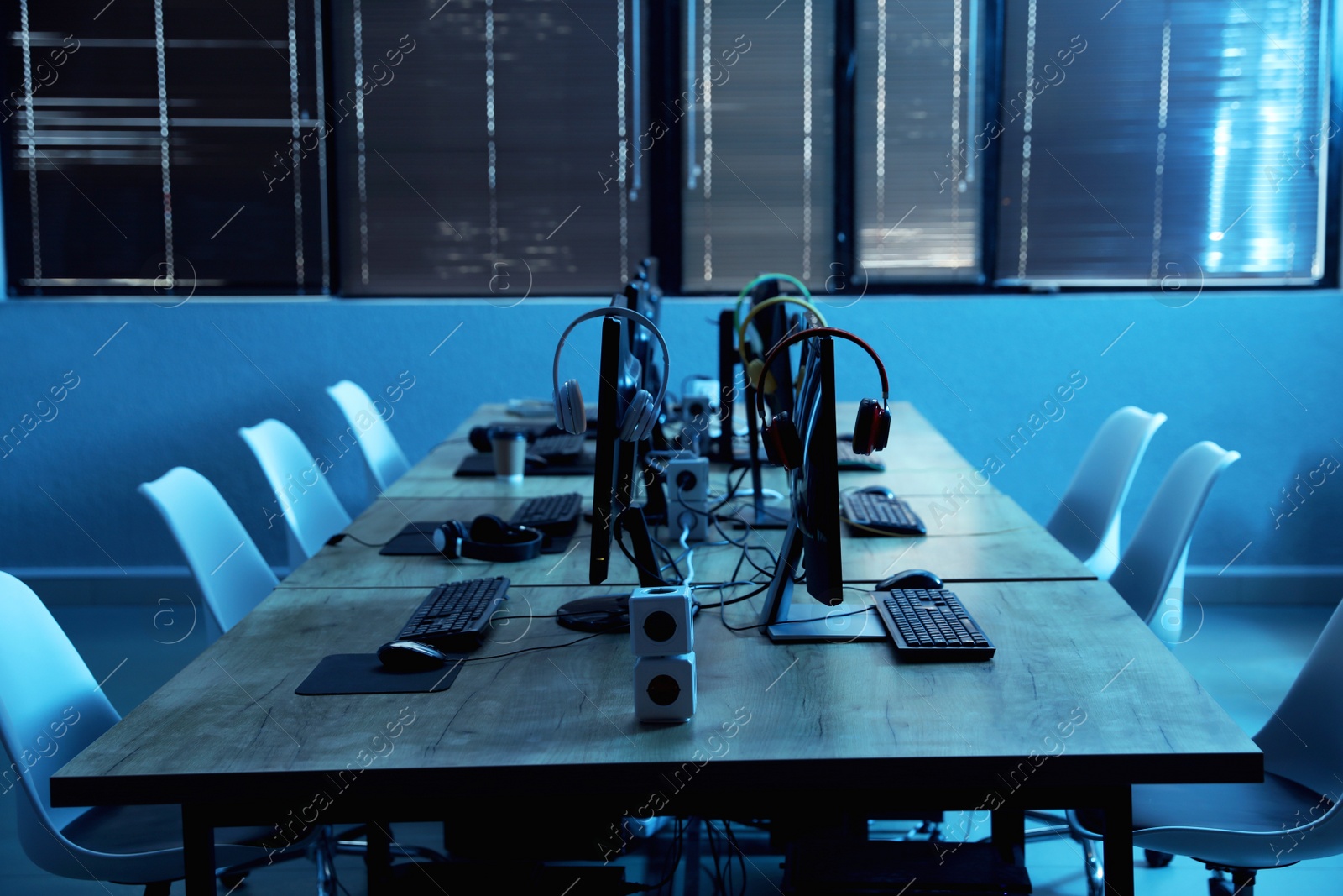 Photo of Internet cafe interior with modern computers. Video game tournament