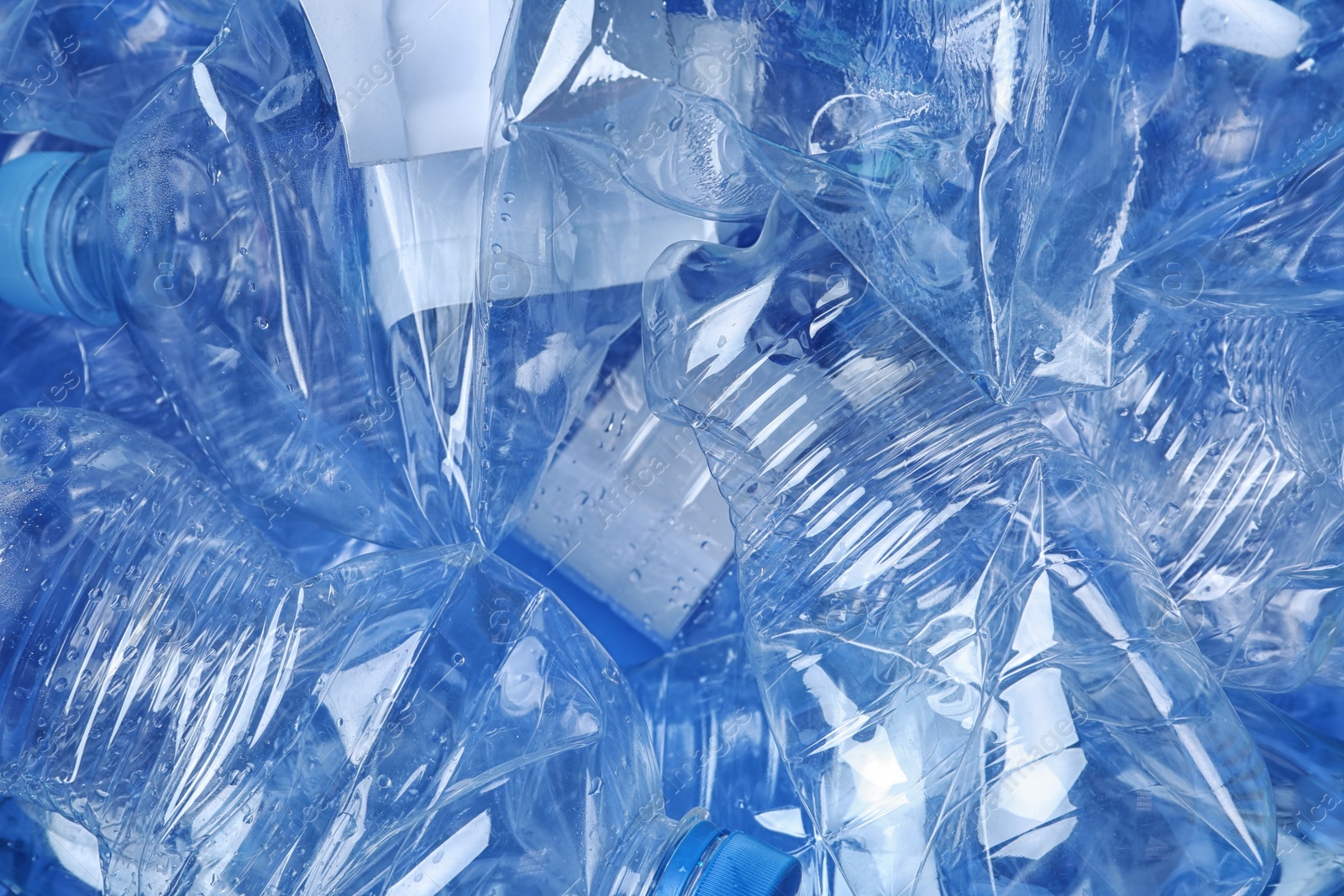 Photo of Pile of crumpled plastic bottles as background, closeup. Recycling problem