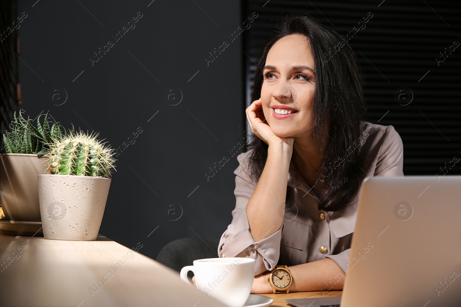 Photo of Beautiful mature woman working with laptop at home