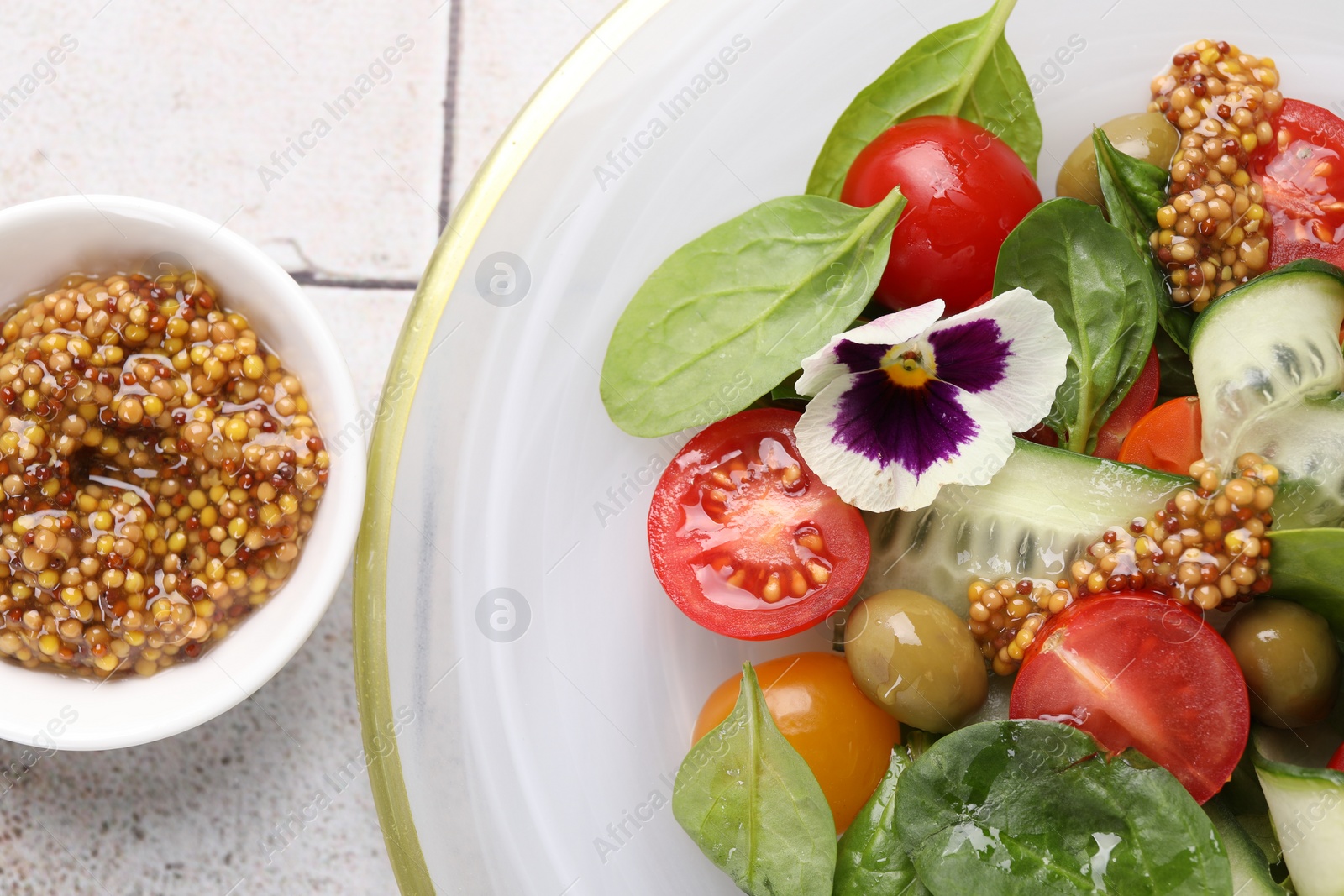 Photo of Delicious salad with vegetables, olives and grain mustard on light table, flat lay