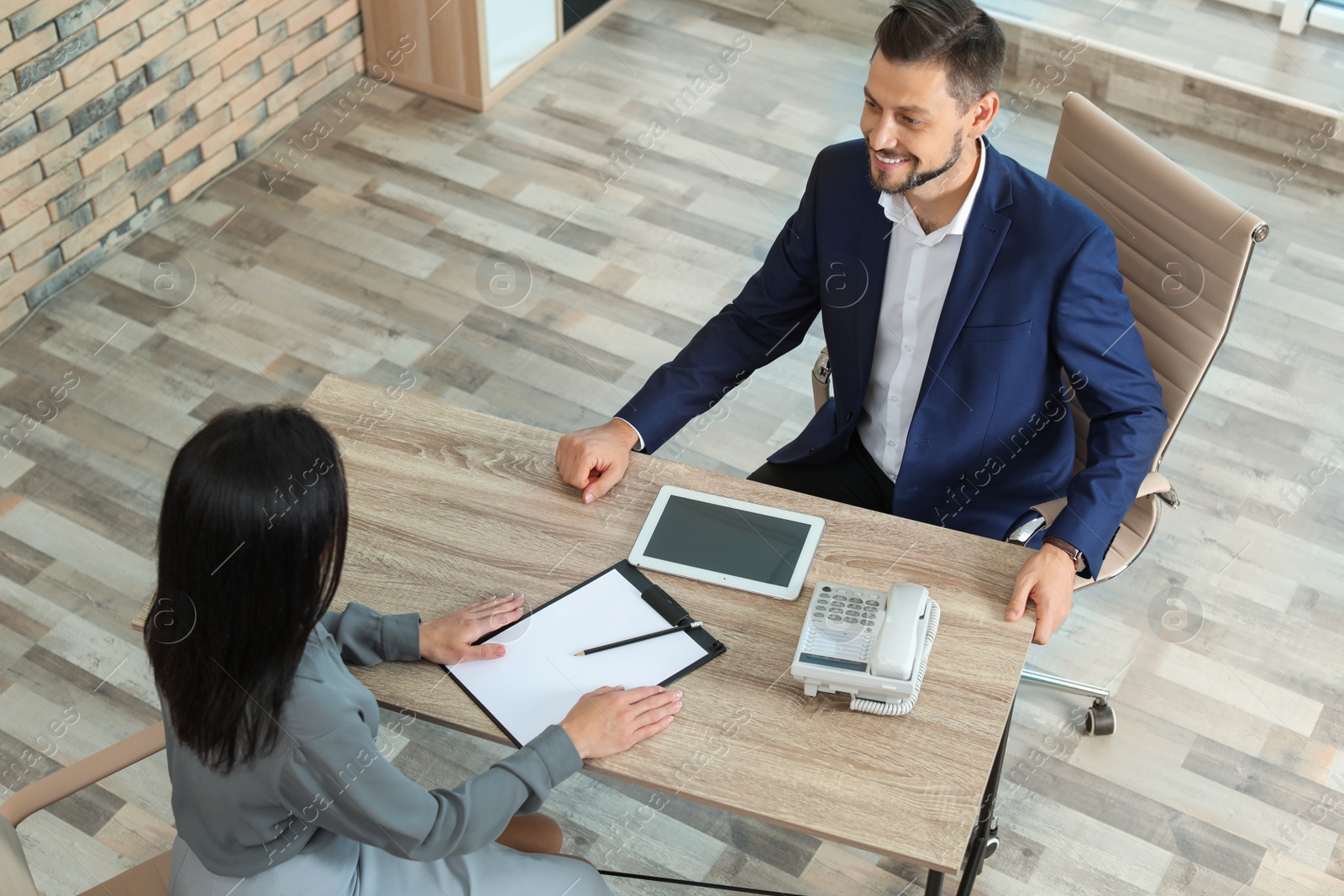 Photo of Human resources manager conducting job interview with applicant in office