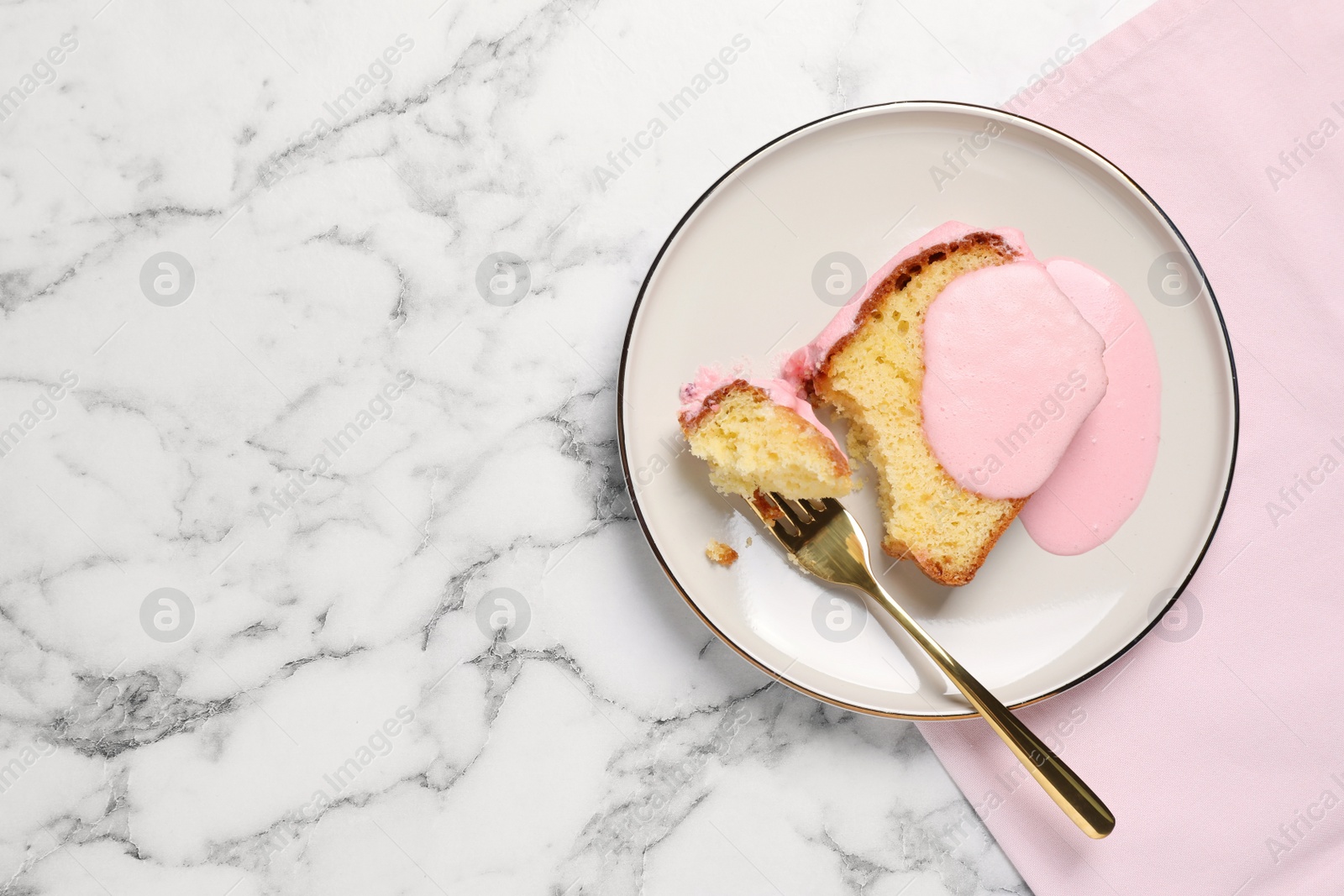 Photo of Delicious cake with pink glaze served on white marble table, flat lay. Space for text
