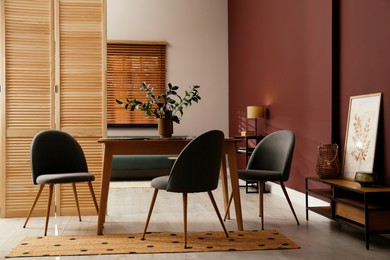 Photo of Beautiful dining room interior with new stylish furniture