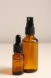 Photo of Bottles with oil on white table. Natural cosmetics