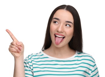 Photo of Happy woman showing her tongue and pointing at something on white background