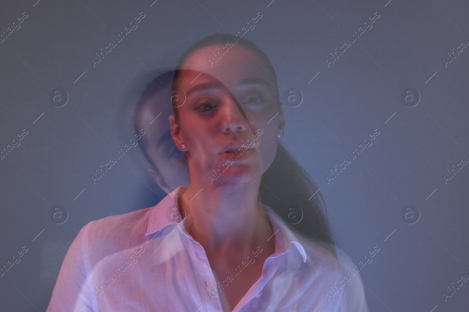 Photo of Portrait of beautiful young woman on color background, long-exposure photography