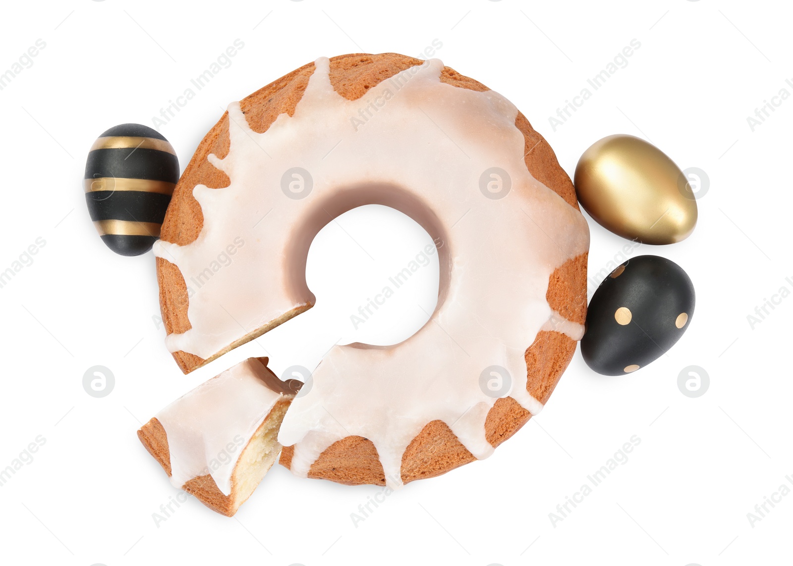 Photo of Traditional Easter cake and festively decorated eggs on white background, top view