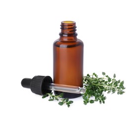 Bottle of thyme essential oil and fresh plant isolated on white