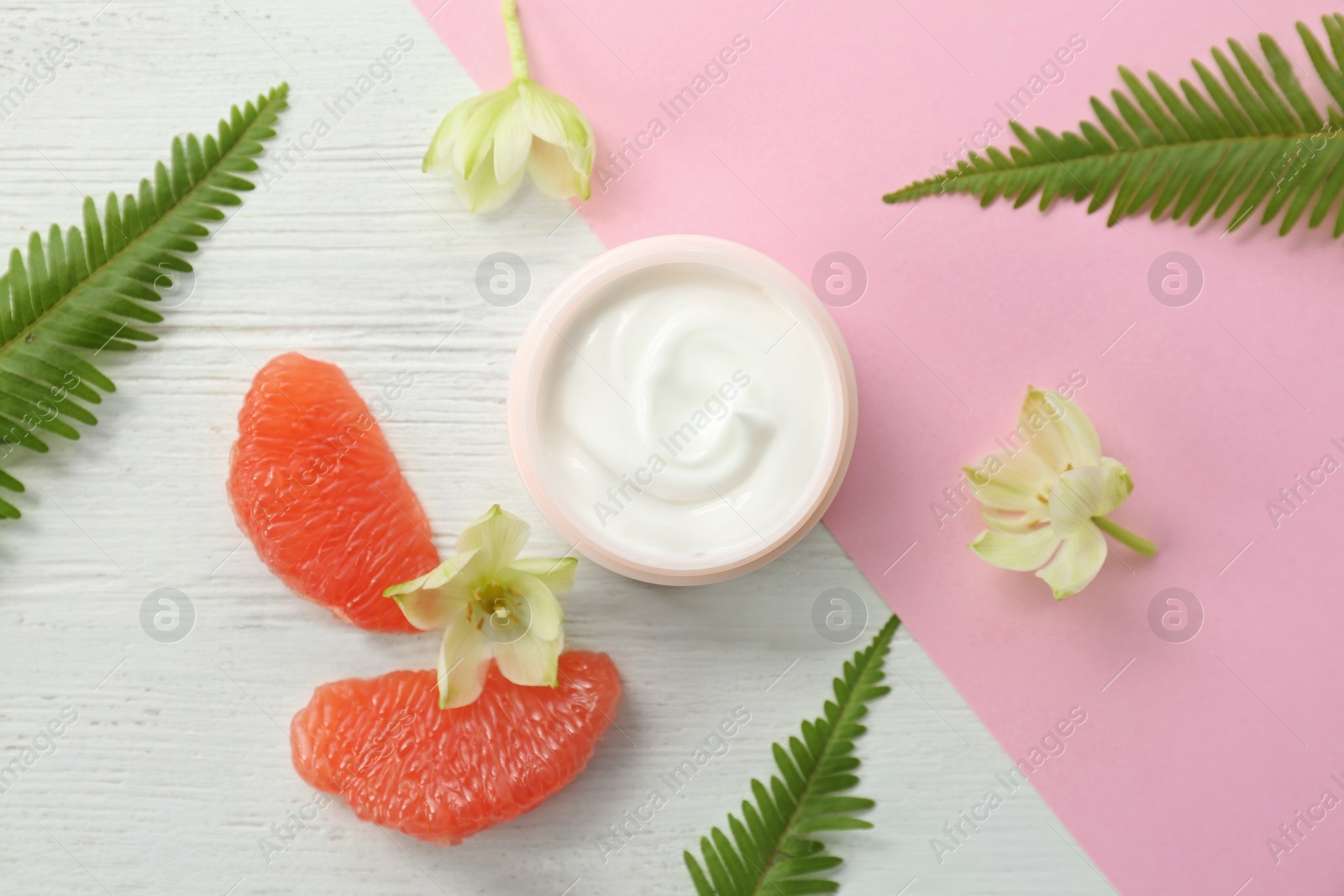 Photo of Beautiful composition with jar of cream on colorful background, flat lay