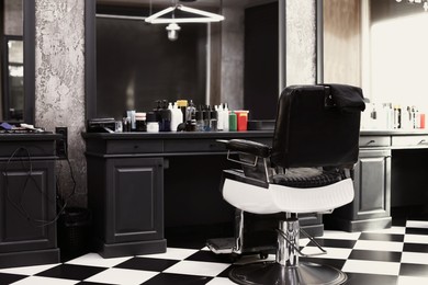Photo of Hairdresser's workplace in modern barbershop. Monochrome interior