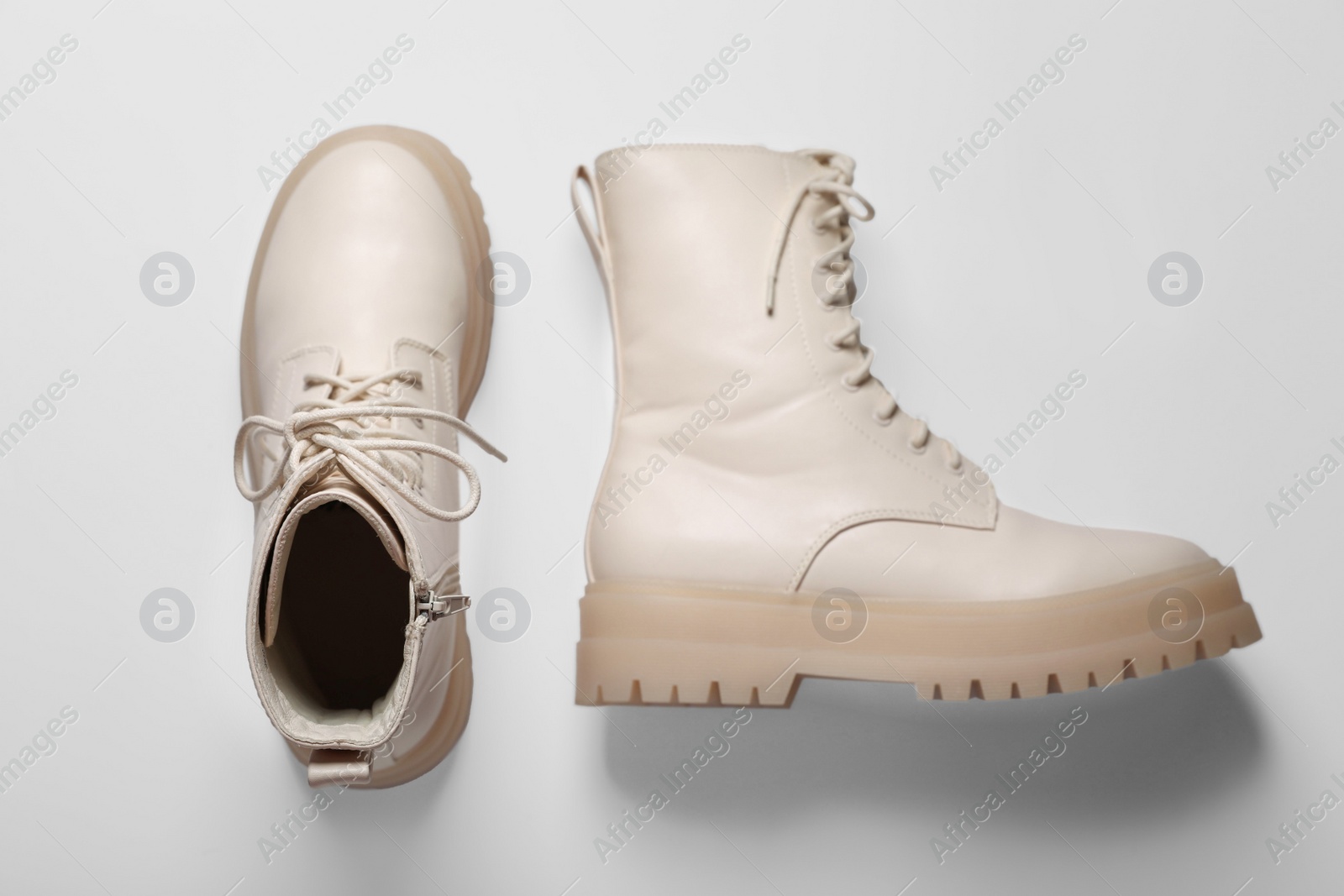 Photo of Pair of stylish leather shoes on beige background, flat lay