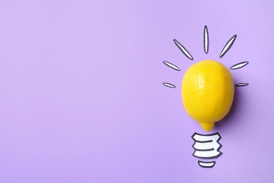 Photo of Composition with lemon as lamp bulb and space for text on violet background, top view. Creative concept